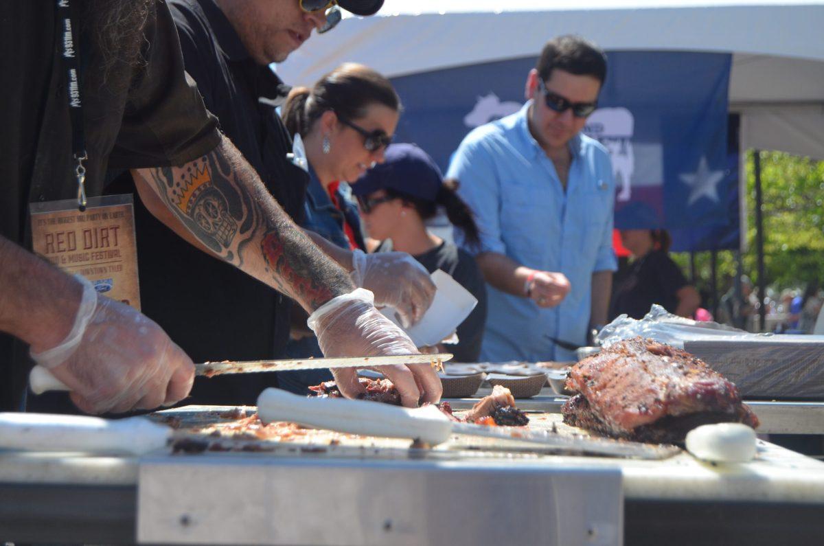 Pitmasters hard at work giving out samples for attendees to try.