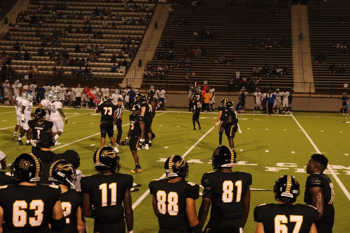 TJC football players on rose stadium field in the middle of a game