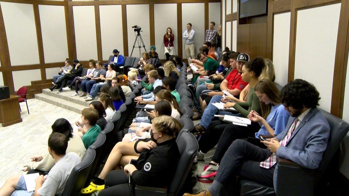 Students sitting in chairs in a meeting