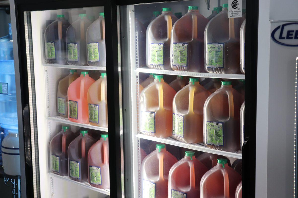 A refrigerator full of different jugs of tea