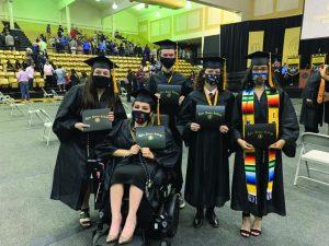 students at a graduation in black gowns