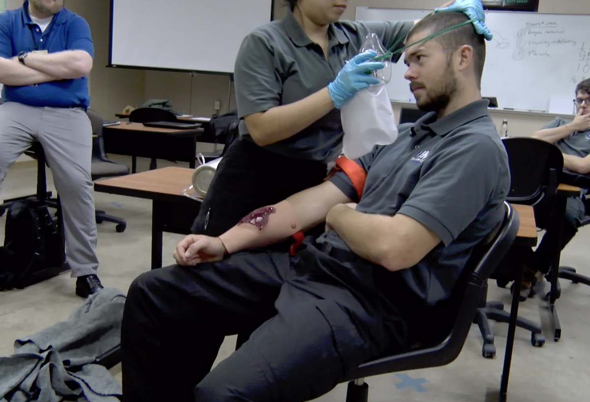 A man practicing a medical procedure