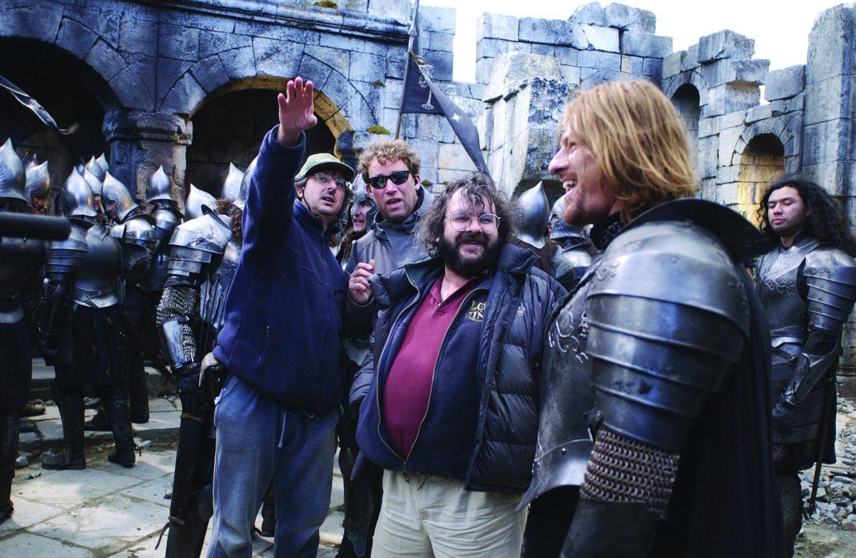 A director showing actors how to move on set