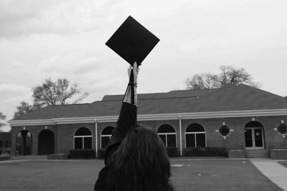 photo illustration of someone holding graduation cap