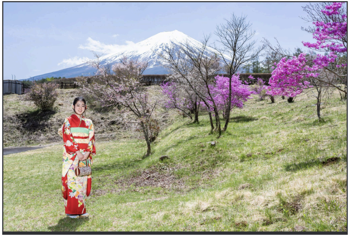 Hanon stands in front of a view Mount Fuji wearing a traditional Japanese garment known as a Kimono.