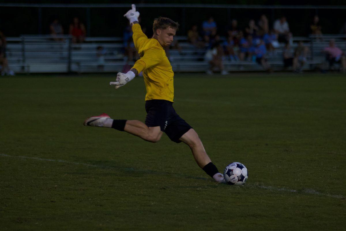 Goalie, Joe Pollard (1), returns the ball to the field after an attempted goal in the second half of the game.