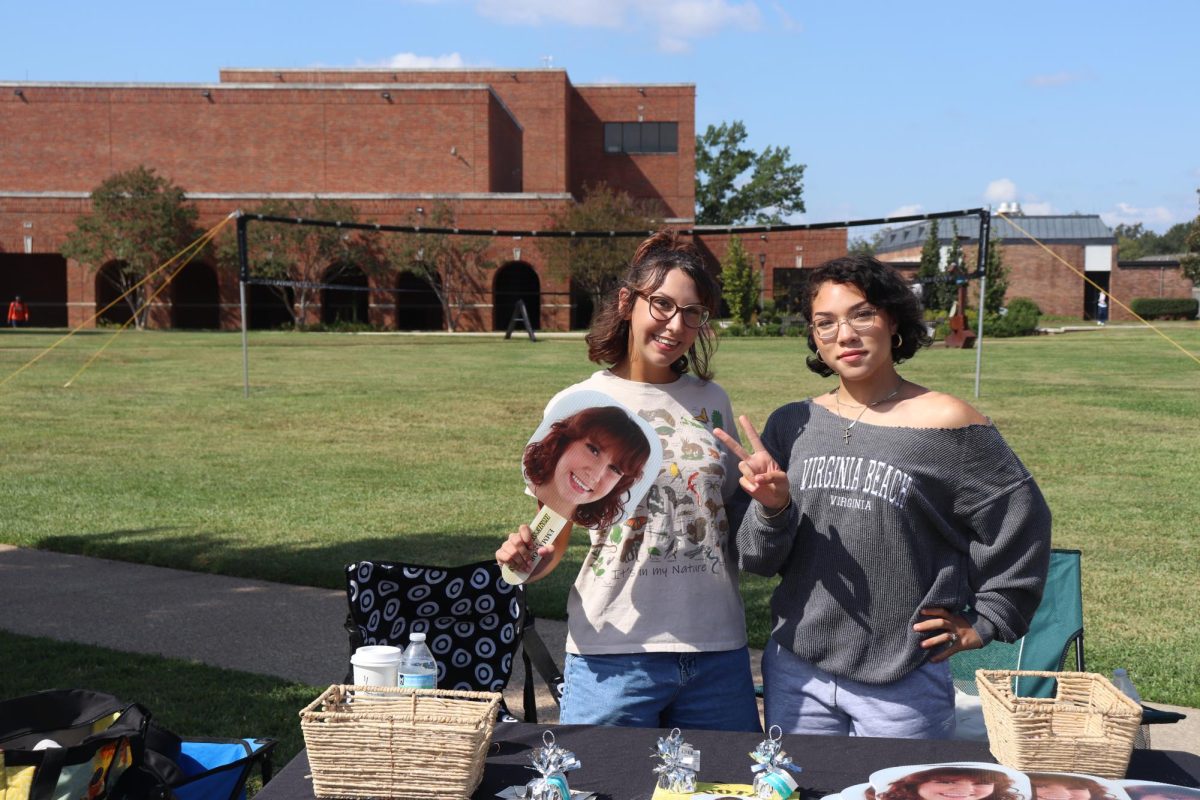 Webb Society table outside of Jenkins hall. Emma Corey (General Studies) is campaigning for homecoming court. Jaylah Black (Premed) is showing support.