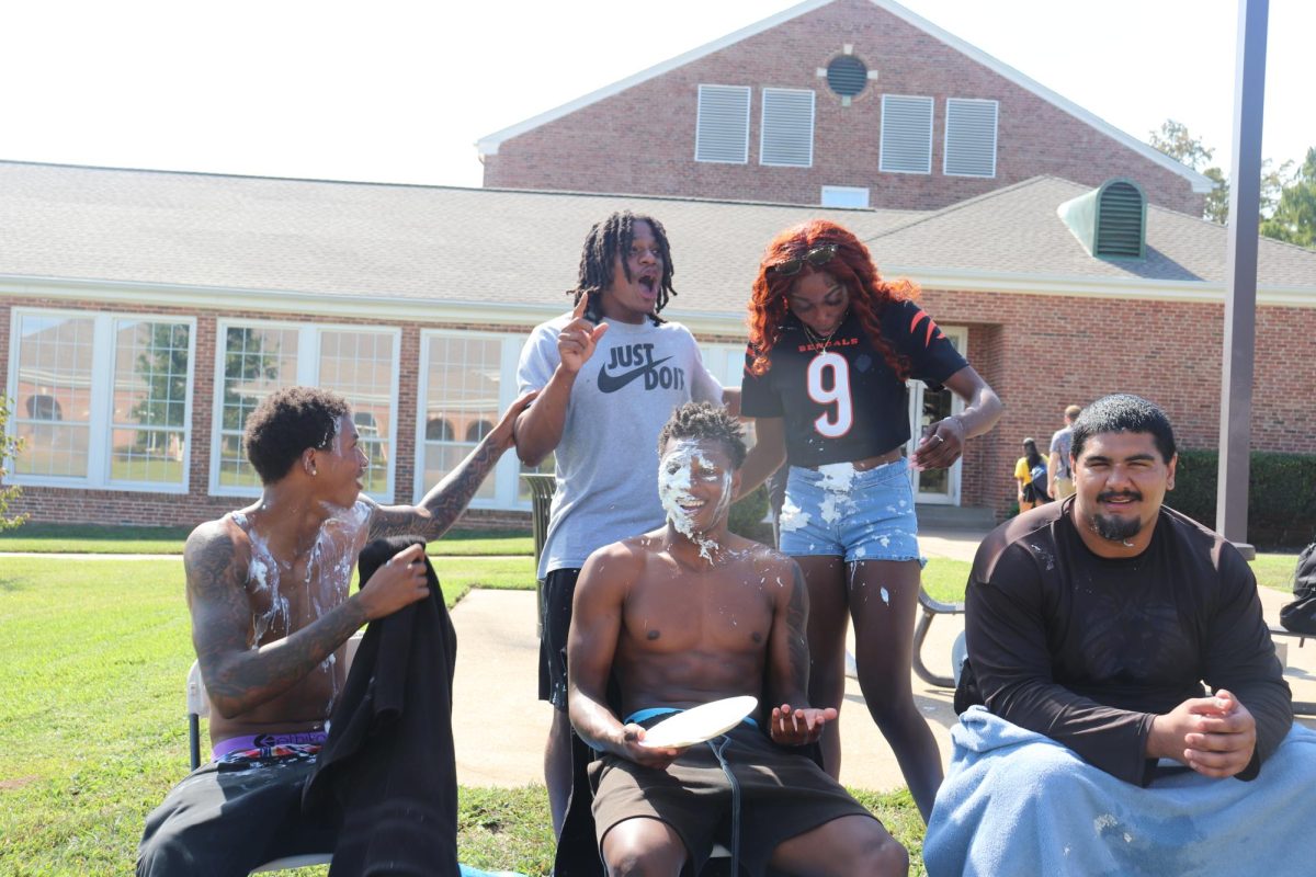 Lawrence Taylor (Business) pies Jamari Evans (General Studies) and the pie flies onto Jada Walker (Education). Khalil Ewell (Business) Hanzlah Rana (Communications)
