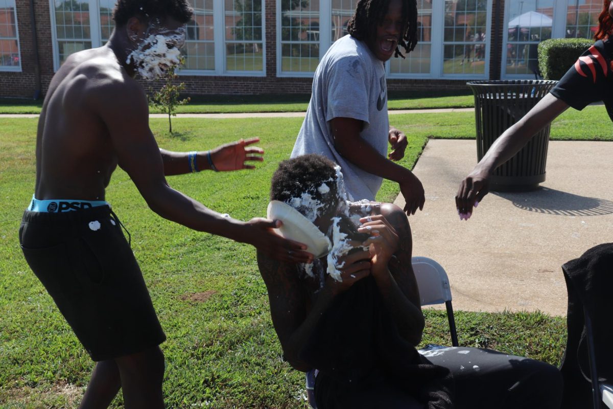 Jamari Evans (General Studies) exacts his revenge on Lawrence Taylor (Business) with Khalil in the background.
