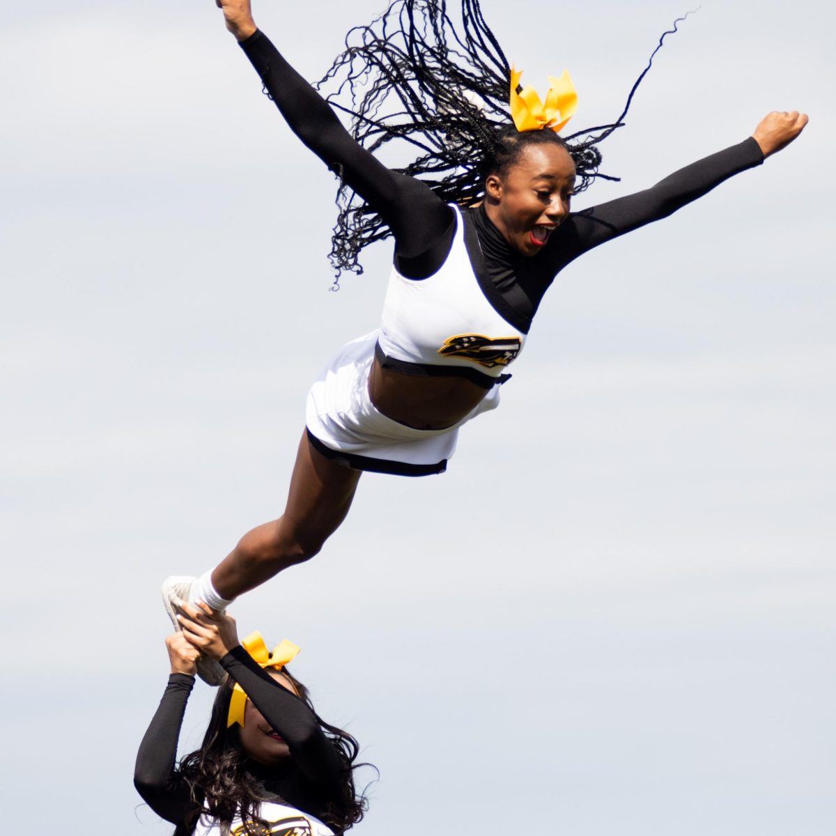 Photo by Ian Frye. TJC Cheer team member Kennedy Miller performing during halftime. The Apache Belles performed alongside the the Apache band. Photo taken on November 1, 2025.