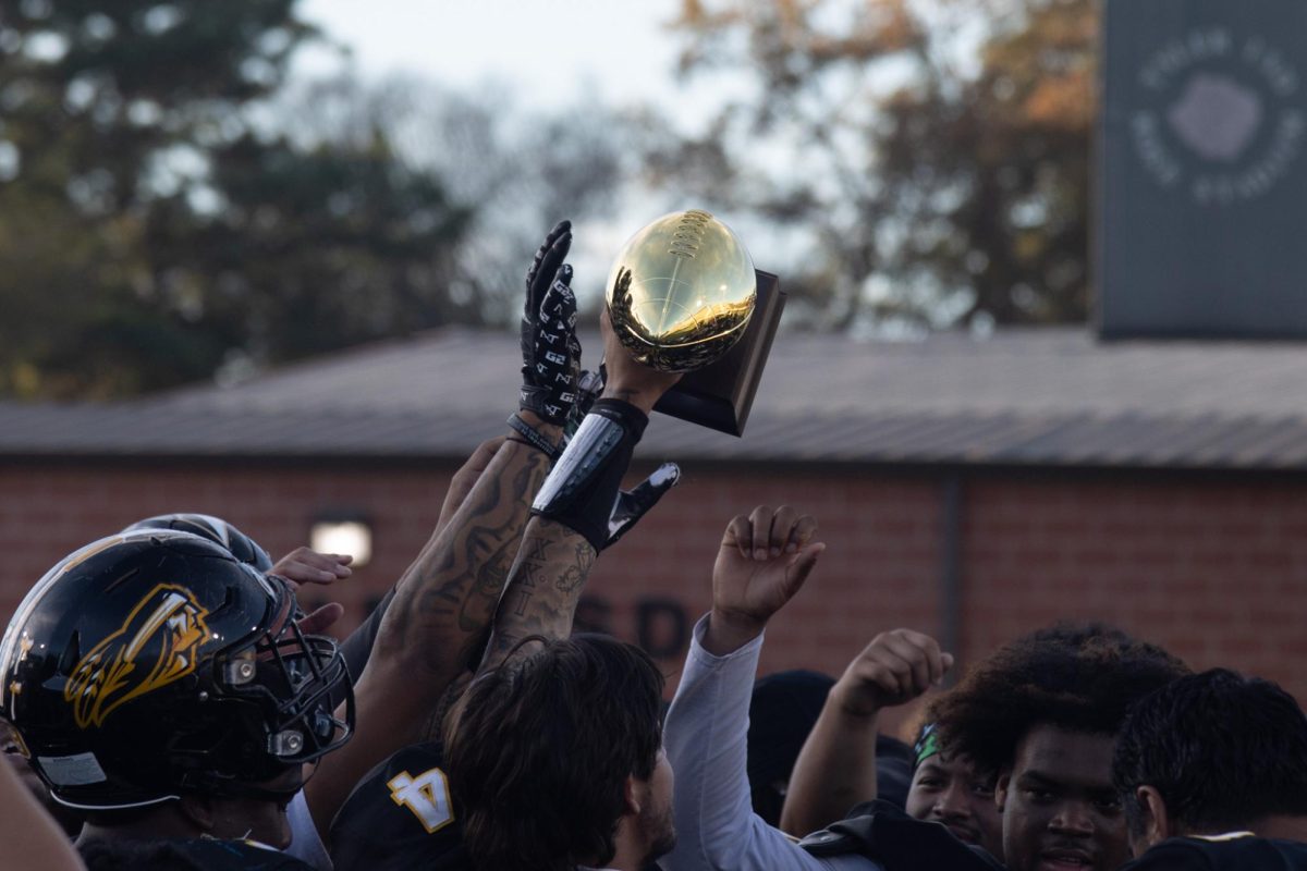 The apaches hoisting the SWJCFC trophy in celebration of their win. The apaches are two games away from a new school record.