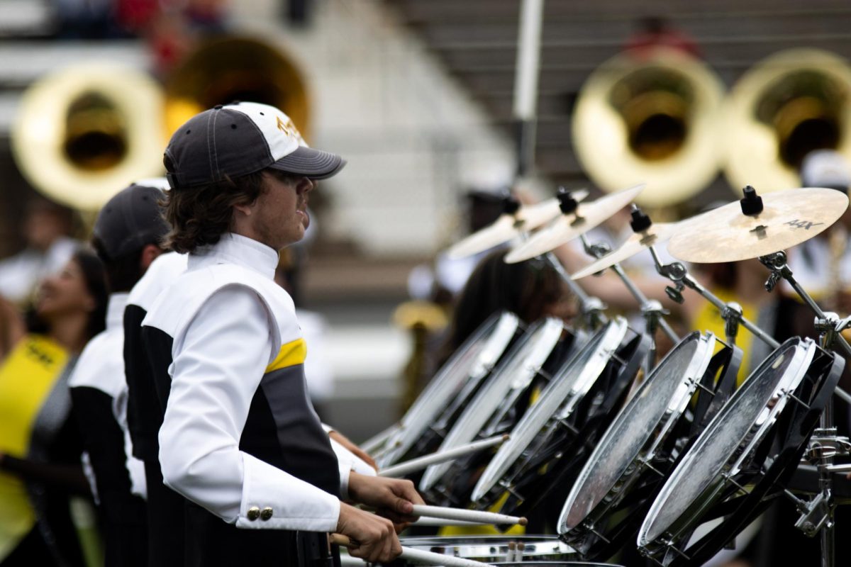Photo by Ian Frye. Band member Aaron Canaday playing drums during halftime. The Apaches were down in the first half of the game but came back and prevented Navarro's win. Photo taken on November 1, 2025.