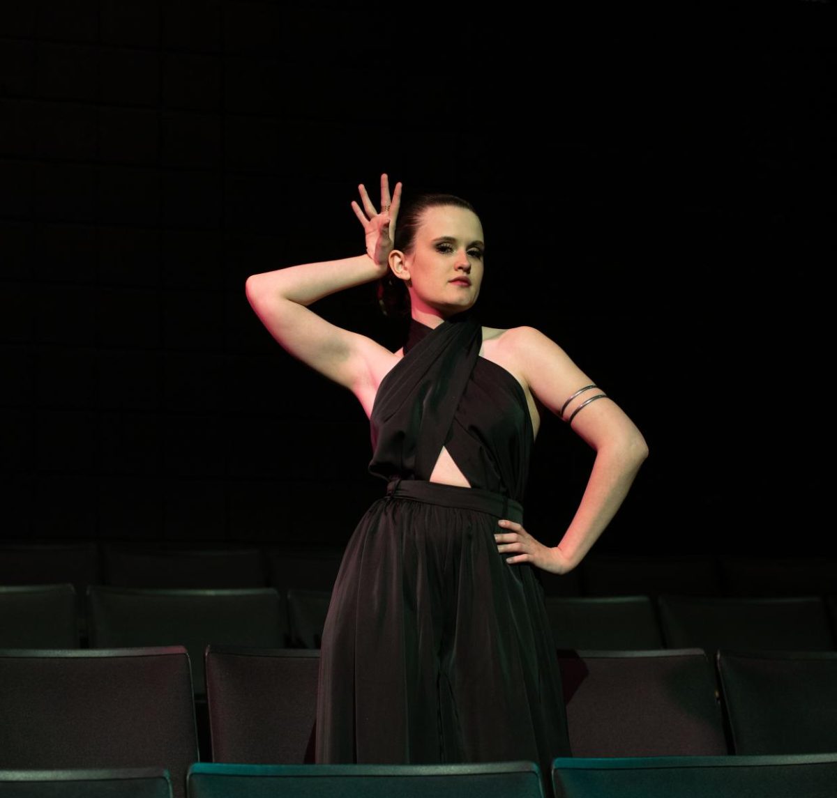 Lexi Brines poses for the camera, showcasing her power and presence gained throughout her TJC Theatre experiences. Brines stands above the seats in the Jean Brown Theatre, depicting how one single "accident" can transform you from being an audience member to a lead actress. Photo Taken by Adriana Salazar Gomez.